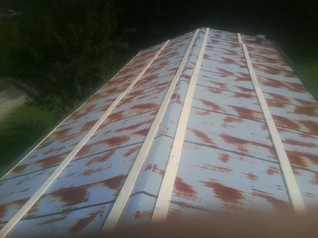 Rusted metal roof panels with new wood purlins before replacement — Storm Damage Roof Repair in Lynbrook by Roofing Brothers