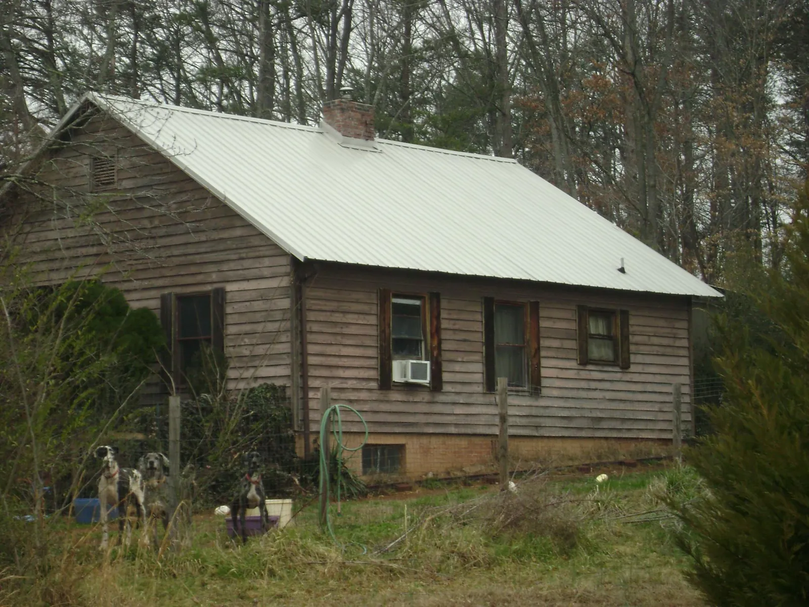 White metal roof on an old wood sided farmhouse, from a Metal Roof Installation job in Lynbrook